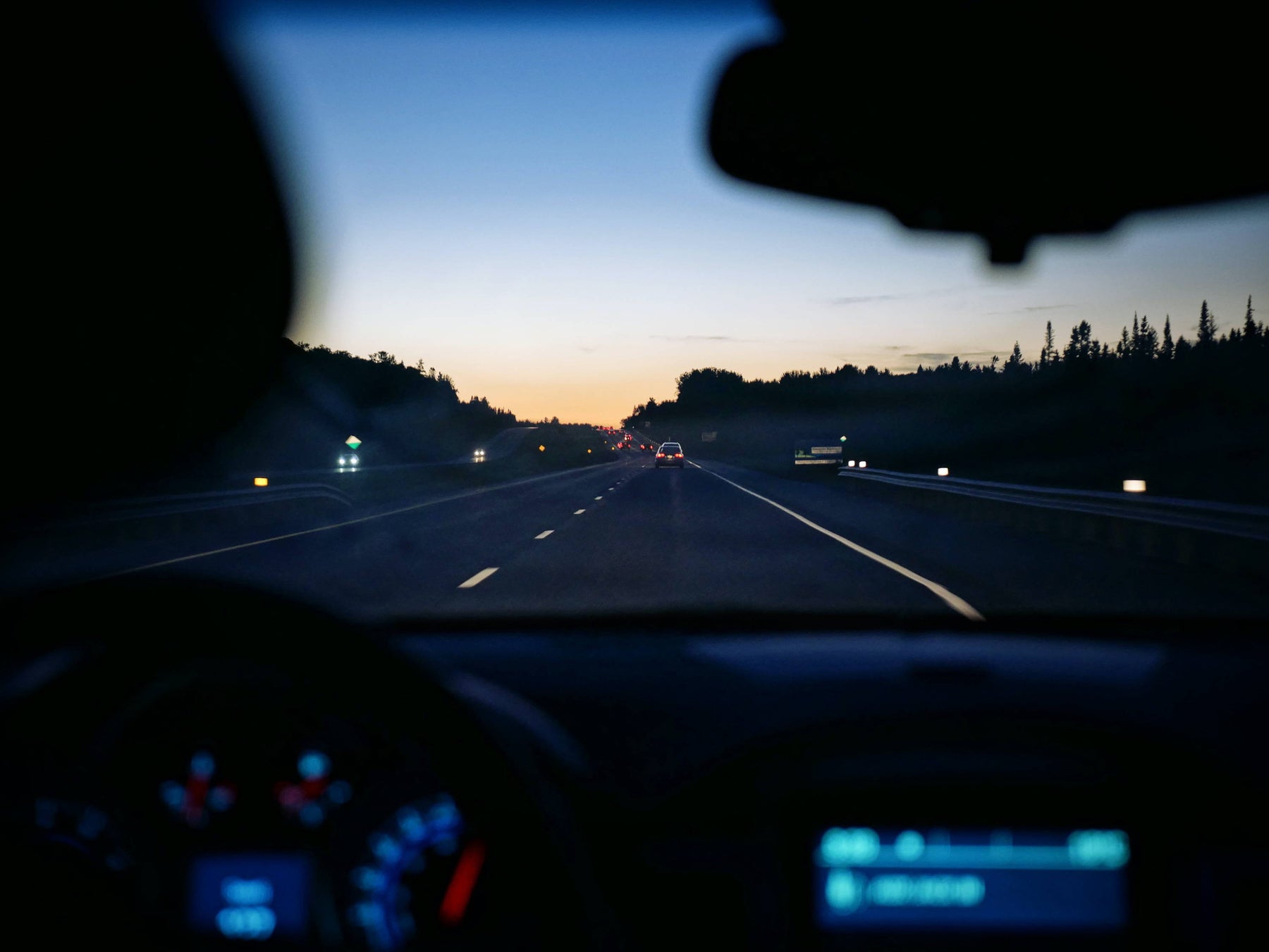 Driver performing seasonal dash cam maintenance