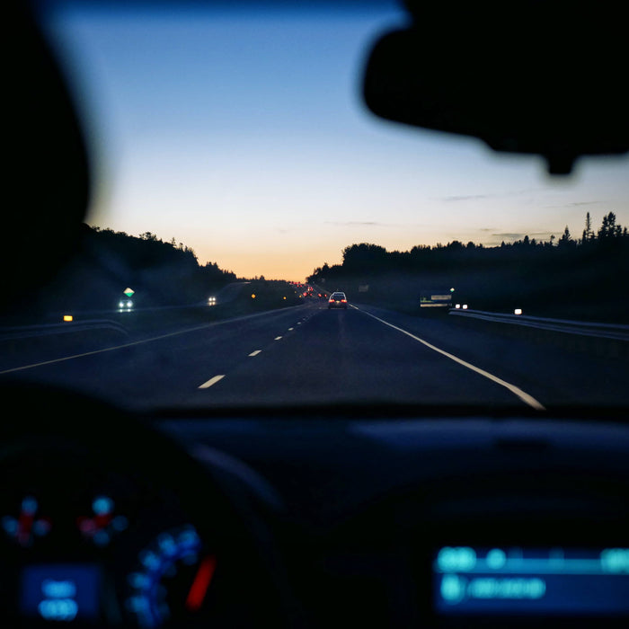 Driver performing seasonal dash cam maintenance