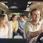 Family seated in a vehicle beneath the installed BlackVue cameras