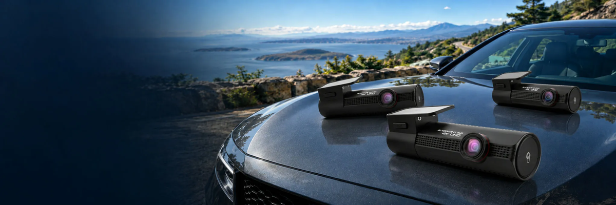 BlackVue Fall Sale dash cams on a vehicle with a coastal mountain backdrop